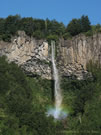 image of a high waterfall with a rainbow near Reigolil, Chile.